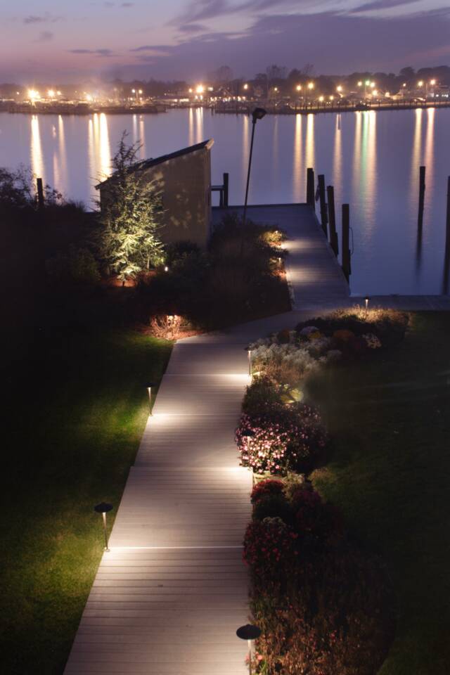 CAST Landscape Lighting. View of dock and landscaping nicely lit.